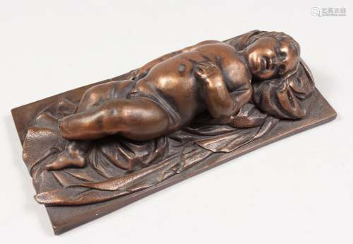 AFTER FRANCOIS DUQUESNOY A GOOD SMALL BRONZE OF A SLEEPING CHILD. 5.5ins long, on a rectangular