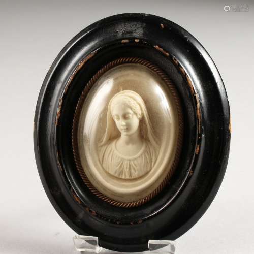AN OVAL CAMEO MINIATURE in a wooden frame. 2.5ins x 2ins.