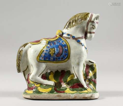 A TURKISH POTTERY HORSE, painted in brilliant colours. 7ins high.