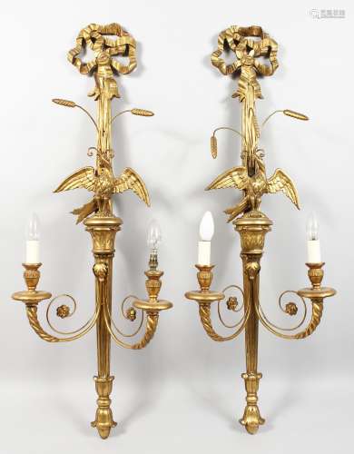 A GOOD PAIR OF CARVED AND GILDED WALL APPLIQUES, 20TH CENTURY, each with a pair of scrolling