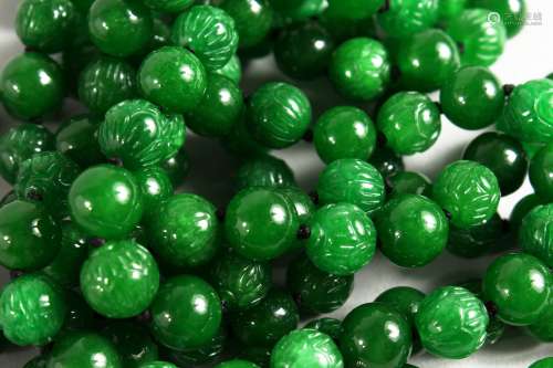 A LONG JADE BEAD NECKLACE with 18ct white gold and diamond clasp. 60ins long.