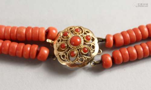 A TWO STRAND CORAL BEAD NECKLACE with 18ct gold clasp. 14ins long.