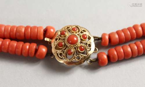 A TWO STRAND CORAL BEAD NECKLACE with 18ct gold clasp. 14ins long.