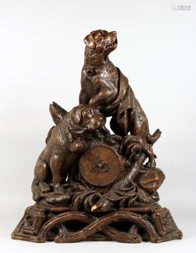 A VERY GOOD ANTIQUE BLACK FOREST CLOCK CARVED WITH TWO SAINT BERNARD DOGS, one with a bell around