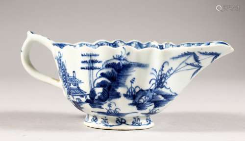 A WORCESTER BLUE AND WHITE RIBBED SAUCEBOAT, Buildings and Trees. 6ins long.