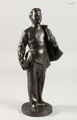 A RUSSIAN METAL STANDING FIGURE OF A MAN, a cape over his shoulders. 11.5ins high.