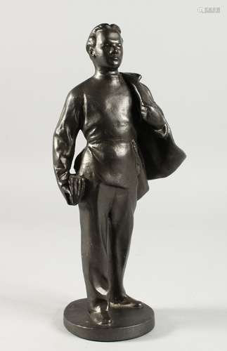 A RUSSIAN METAL STANDING FIGURE OF A MAN, a cape over his shoulders. 11.5ins high.