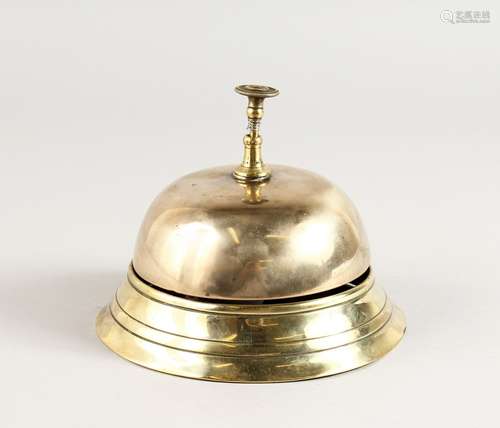 A CIRCULAR BRASS DESK BELL. 5.5ins diameter.