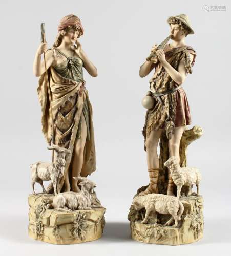A PAIR OF ROYAL DUX SHEPHERD AND SHEPHERDESS with lambs and goats on rocky bases. Triangular mark.