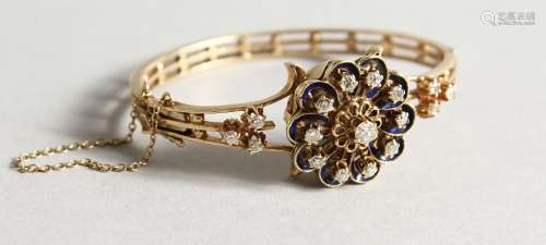 A LADIES' 14CT GOLD AND DIAMOND BANGLE WATCH with a flowerhead design hinged cover set with a