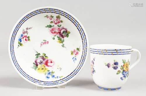 AN 18TH CENTURY SEVRES COFFEE CUP AND SAUCER, painted with flowers under three blue lines,