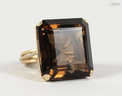 A 9CT GOLD AND LARGE TOPAZ RING.