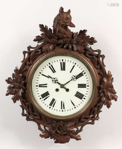AN ANTIQUE BLACK FOREST CARVED WOOD WALL CLOCK, carved with an animals head, hunting horn and oak