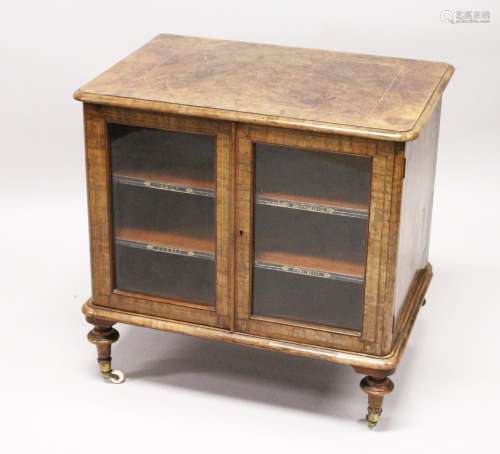 A VICTORIAN WALNUT LOW TWO DOOR MUSIC CABINET, with two shelves, on turned feet. 2ft 3ins wide x 2ft