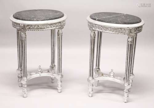 A PAIR OF FRENCH STYLE CARVED AND SILVERED WOOD LAMP TABLES, with oval marble tops. 2ft 4ins high