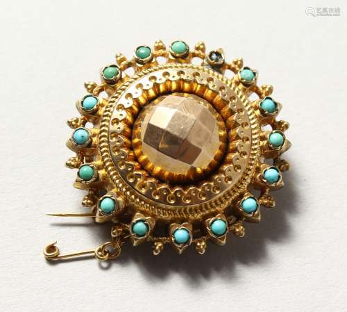 A GOLD AND TURQUOISE BROOCH.