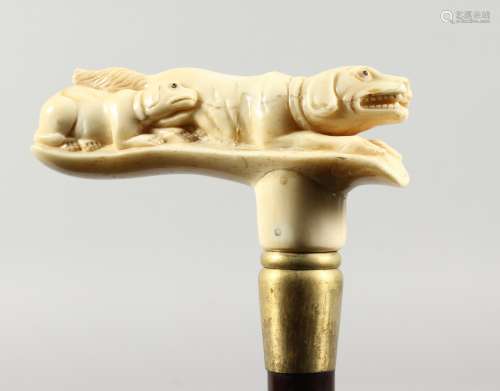 A WALKING STICK the bone handle carved as a two dogs.