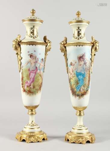 A PAIR OF TALL, SLENDER SEVRES STYLE PORCELAIN VASES with ormolu mounts. 21ins high.
