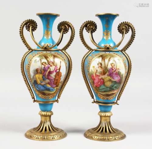 A GOOD PAIR OF 19TH CENTURY SEVRES PORCELAIN AND ORMOLU TWO HANDLED VASES, pale blue ground