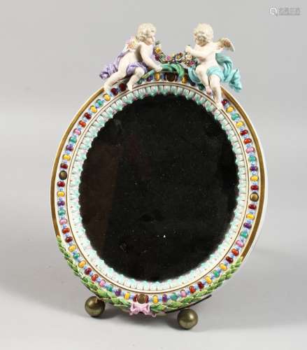 A GOOD 19TH CENTURY MEISSEN OVAL MIRROR with cupid holding a garland. Bevelled mirror 9ins x 7ins.