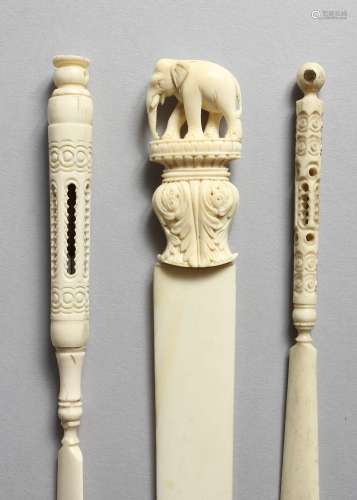 TWO CARVED IVORY STANHOPES, one of Portsmouth, 6ins long, and a paper knife carved with an elephant,