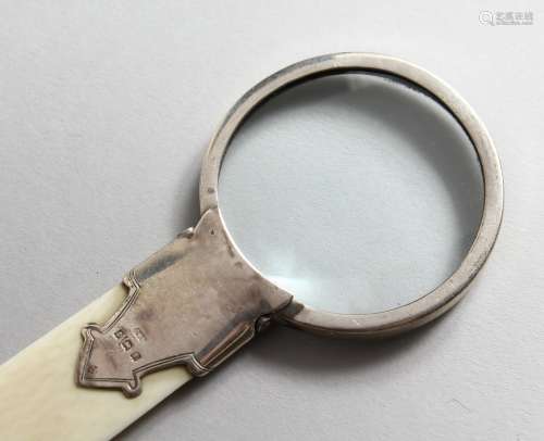A SILVER MOUNTED IVORY MAGNIFYING GLASS. Birmingham 1910. 8.5ins long.