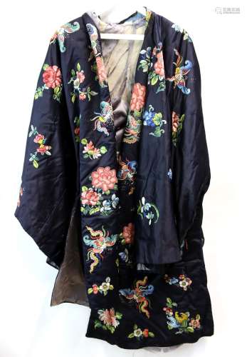 A Chinese textile coat, decorated on the night-blue ground with designs of natural history;
