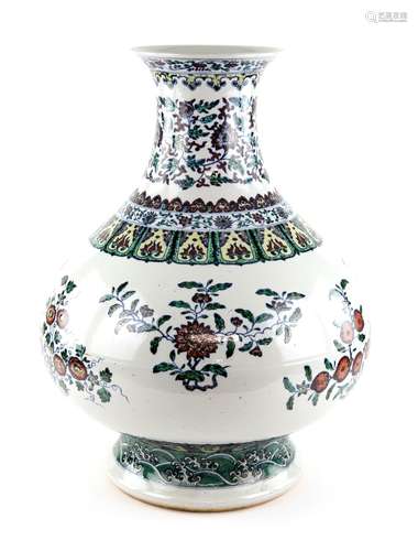 A large doucai style vase with trumpet neck, decorated with floral designs beneath a band of