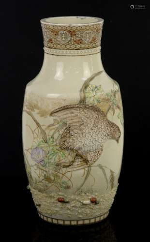 A Satsuma vase, decorated with a bird-of-prey in high relief, chasing a butterfly; 35 cm high; the