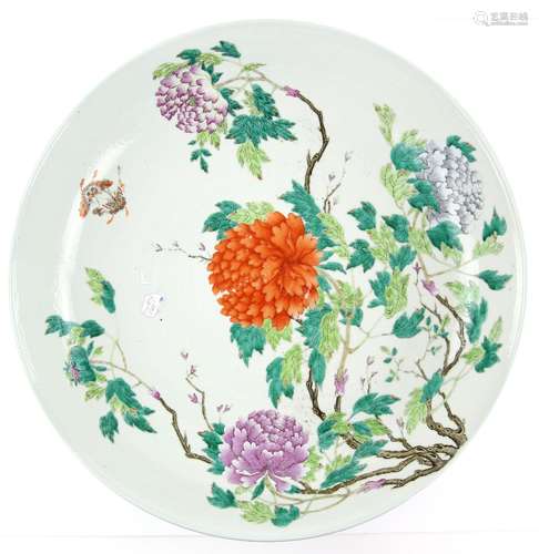 A large Chinese dish of circular form, decorated with a bold polychrome design of flowers and