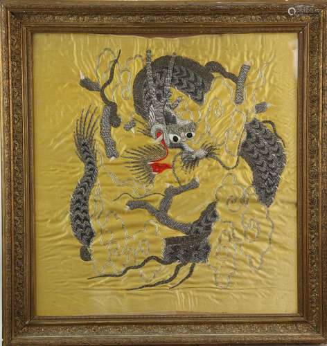 A yellow-ground Chinese textile, designed with a dragon beside cloud scrolls; late Qing Dynasty or