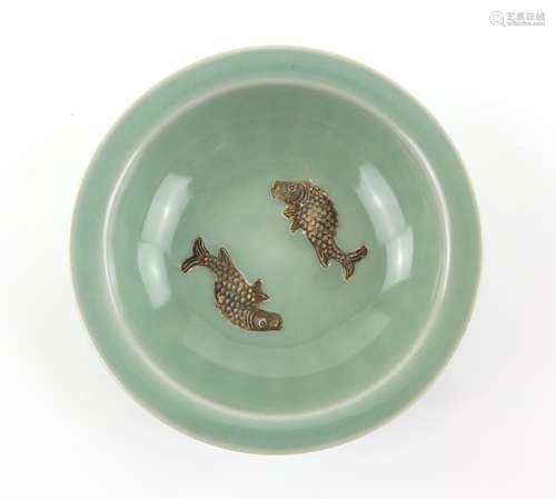 A small celadon bowl in the Song or Ming style, decorated with two fish in the well, 13.5 cm