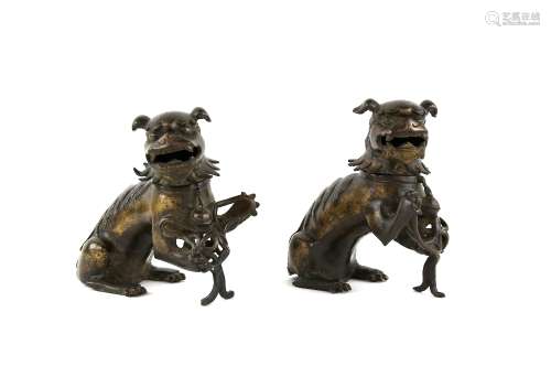 A pair of Chinese gilded-metal alloy incense burners; each one modelled as a Buddhistic Lion with