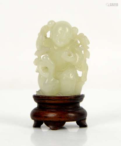 A small Chinese green jade figure of a boy standing beside a duck; about 5 cm high; with a wood