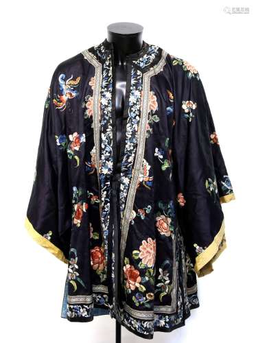 A Chinese dark blue ground tunic, decorated with natural history designs; overall length from collar