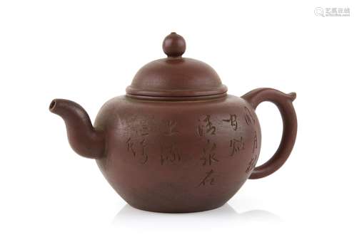 A Yi Xing teapot with loop handle and domed cover, decorated with an inscription on the exterior,