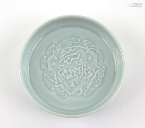 A Qingbai style monochrome saucer dish, decorated with bats; underglaze blue six-character mark of