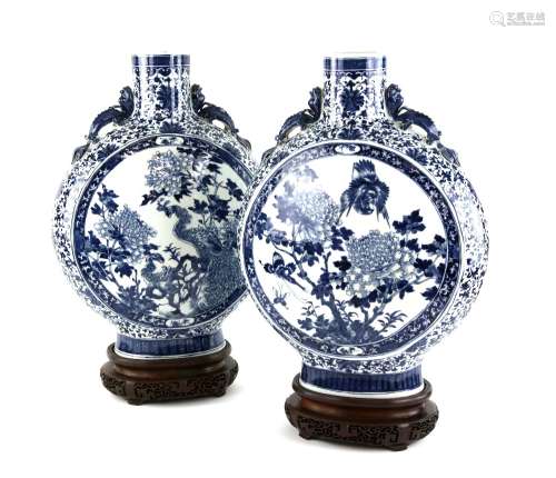 A large pair of blue and white pilgrim-shaped vases; each one decorated with bold designs of Birds