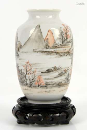 A Chinese vase, decorated en-grisaille and orange highlights with scholars and river craft in a