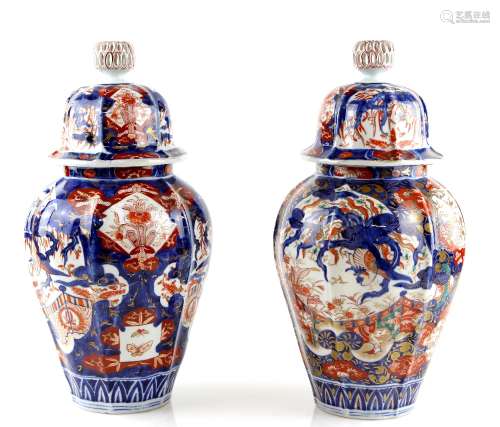 An associated pair of Japanese Imari vases; each one with domed cover and reticulated knop finial,