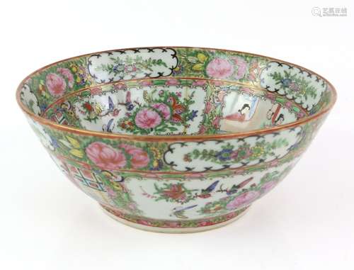 A Canton famille rose bowl, decorated with typical panels of Manchu/Chinese figures and Natural