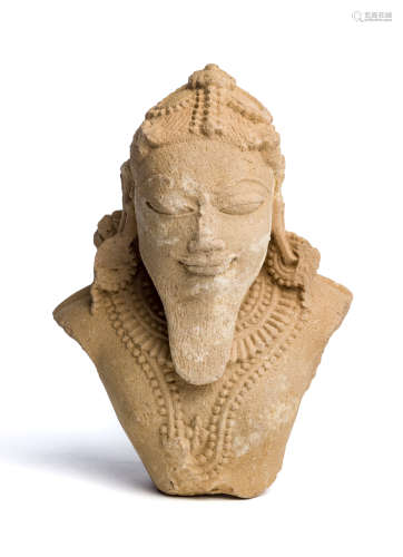 A BUFF SANDSTONE FRAGMENTARY BUST OF A MALE DEITY, MADHYA PRADESH OR RAJASTHAN, 11TH / 12TH CENTURY