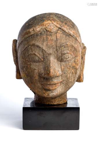 A CARVED WOOD HEAD OF A WOMAN, WESTERN INDIA, 18TH / 19TH CENTURY