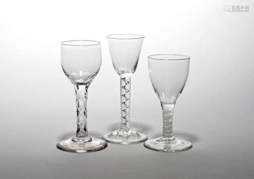 Three wine glasses c.1760, one with a rounded funnel bowl raised on a corkscrew airtwist stem,