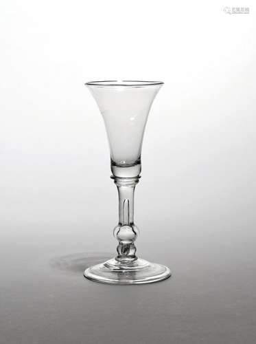 A balustroid wine glass c.1740, the slender bell bowl raised on a stem with inverted baluster knop