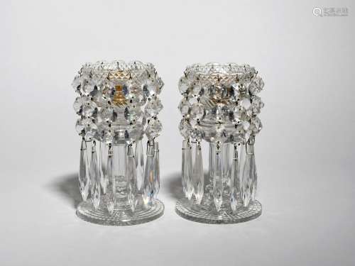 A pair of cut glass table lustres 19th century, hung with strings of circular and drop lustres,