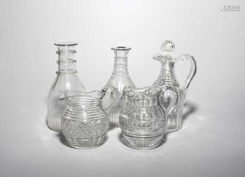 A pair of glass carafes early 19th century, cut with bands of polished lappets and shallow neck