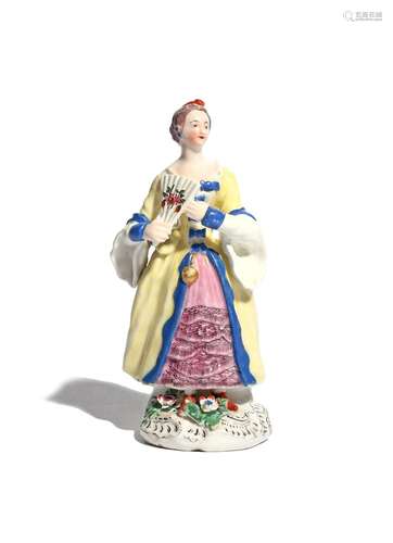 A rare Bow figure of a lady c.1758-60, copying a Meissen model by Peter Reinicke, wearing a