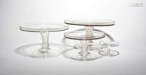 Three glass tazzae mid 18th century, in three sizes, with flat circular tops with galleried rims,