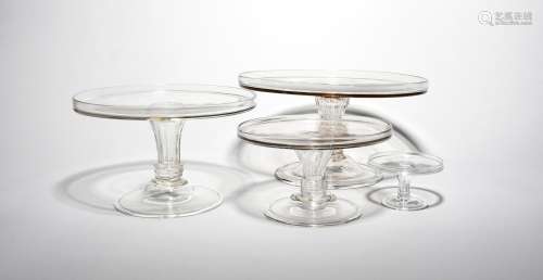 Three glass tazzae mid 18th century, in three sizes, with flat circular tops with galleried rims,
